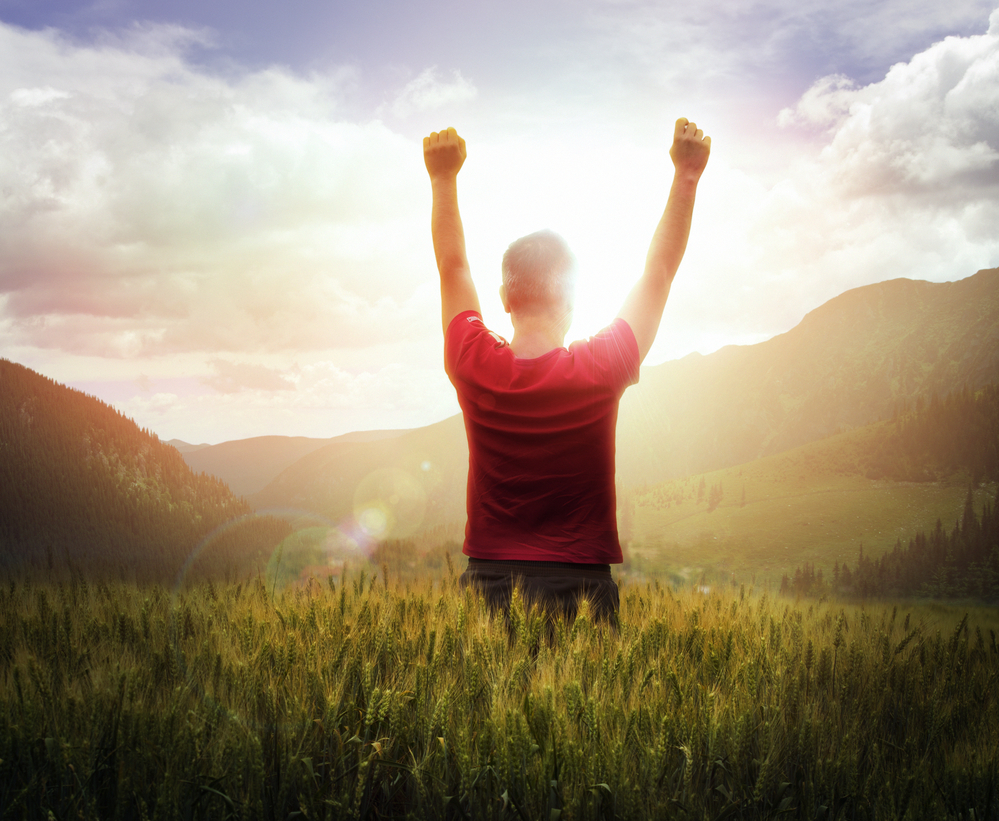 Young man standing in the middle of a peaceful forest