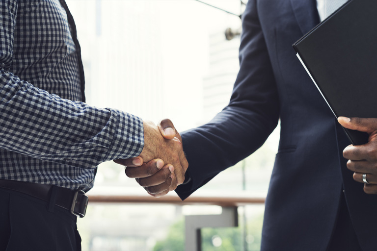 Man having a handshake after a guaranteed deal of his gig service